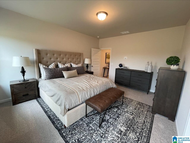carpeted bedroom featuring baseboards and visible vents