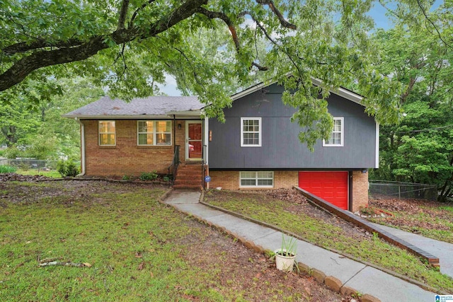 2105 NE 5th St NE, Center Point, AL 35215 - view of front of property featuring fence, an attached garage, driveway, and brick siding