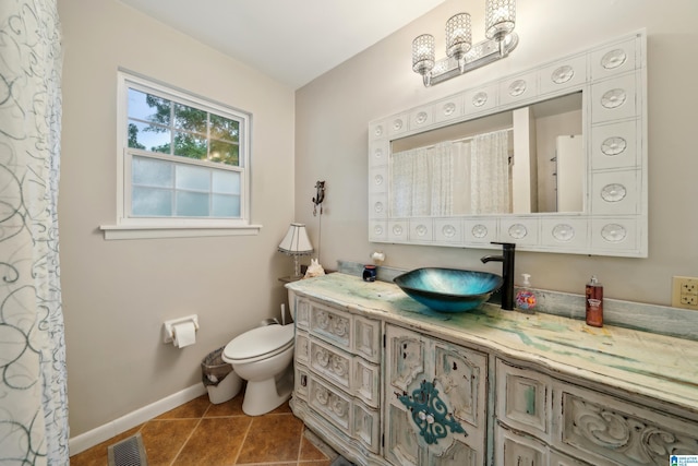 2105 NE 5th St NE, Center Point, AL 35215 - full bath with visible vents, vanity, toilet, baseboards, and tile patterned floors
