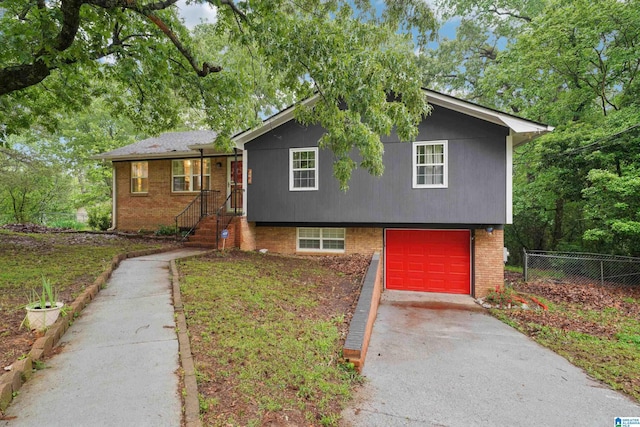 2105 NE 5th St NE, Center Point, AL 35215 - tri-level home featuring brick siding, an attached garage, fence, and aphalt driveway