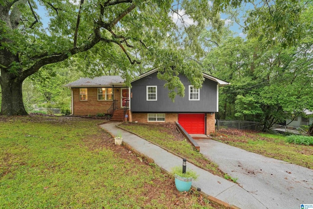 2105 NE 5th St NE, Center Point, AL 35215 - tri-level home with a front lawn, fence, brick siding, an attached garage, and driveway