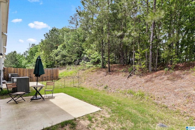 view of yard with central air condition unit, a patio area, and fence