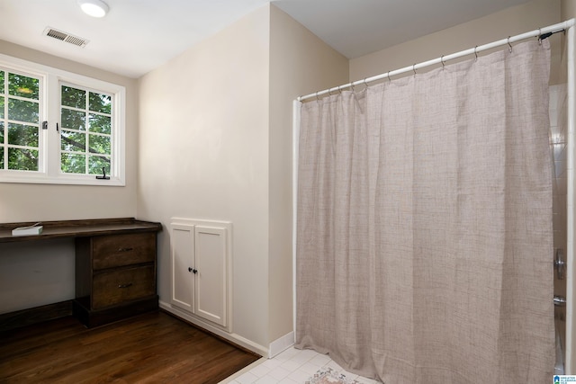 bathroom with baseboards, visible vents, and a shower with shower curtain