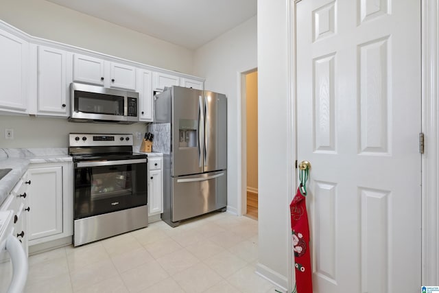 108 Tocoa Cir, Helena, AL 35080 - kitchen featuring baseboards, white cabinetry, appliances with stainless steel finishes, and light stone countertops