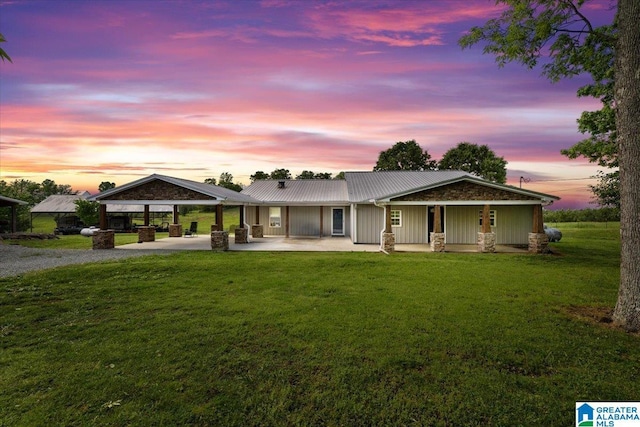 239 Gilliland Rd, Oneonta, AL 35121 - view of front of house featuring a carport, metal roof, a yard, and gravel driveway