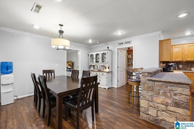 239 Gilliland Rd, Oneonta, AL 35121 - dining area with visible vents, crown molding, and dark wood-type flooring