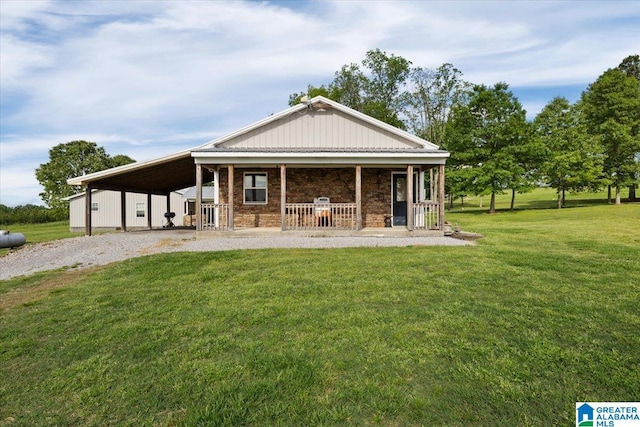 239 Gilliland Rd, Oneonta, AL 35121 - rear view of property featuring stone siding, a porch, a carport, a yard, and gravel driveway