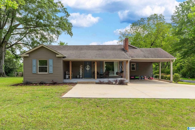 view of front facade with an attached carport, a porch, a front yard, a chimney, and driveway