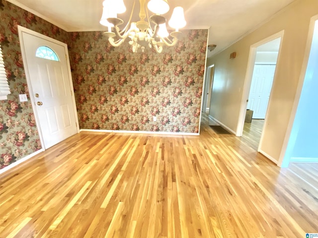 unfurnished dining area featuring baseboards, a chandelier, and light wood-type flooring
