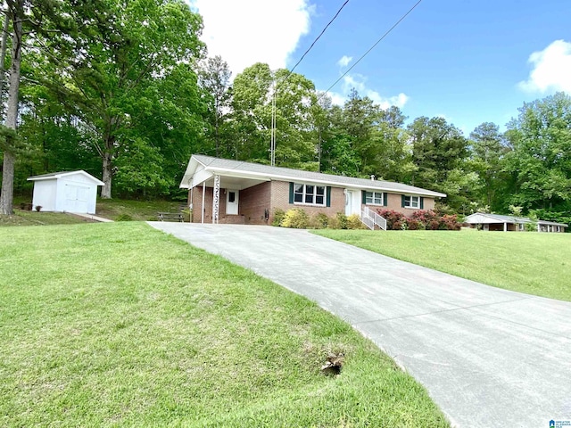 ranch-style home with a storage shed, a carport, brick siding, a front lawn, and concrete driveway