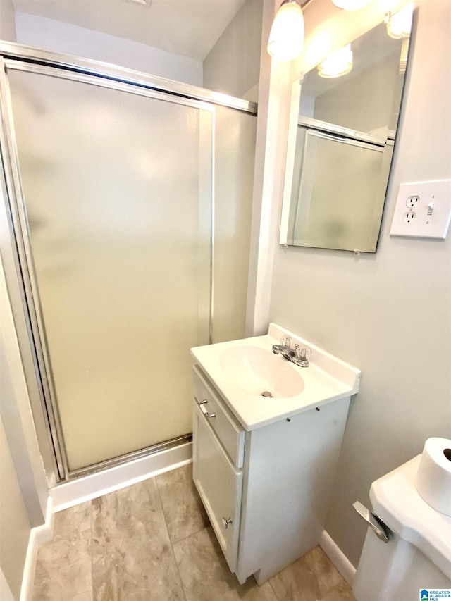 bathroom with baseboards, a sink, and a shower stall