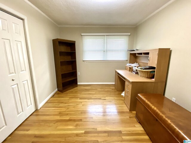 office with crown molding, a textured ceiling, baseboards, and light wood-type flooring