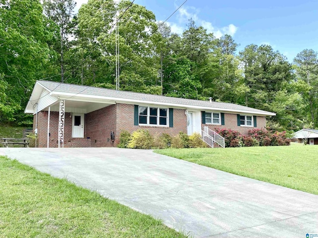 single story home with concrete driveway, brick siding, a carport, and a front lawn