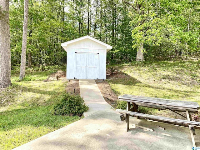 view of shed with a wooded view