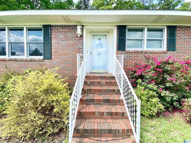 doorway to property with brick siding