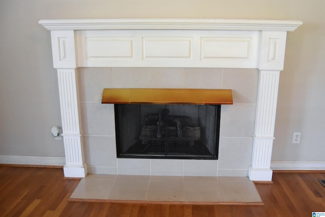 602 Riddle Ave, Piedmont, AL 36272 - details featuring a tiled fireplace, baseboards, and wood finished floors