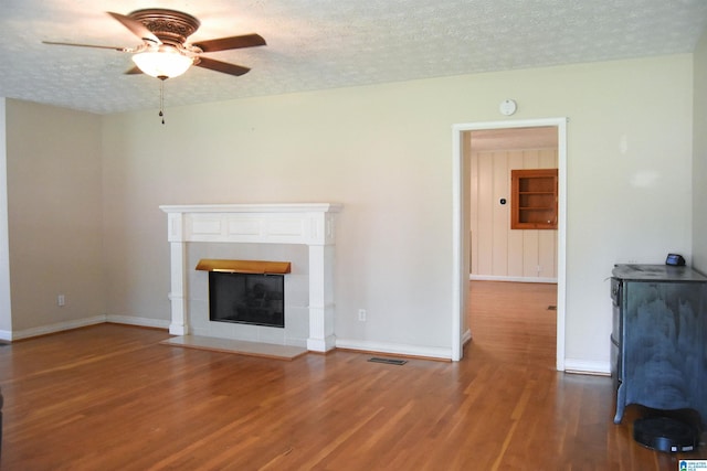 602 Riddle Ave, Piedmont, AL 36272 - unfurnished living room with baseboards, ceiling fan, a textured ceiling, and wood finished floors