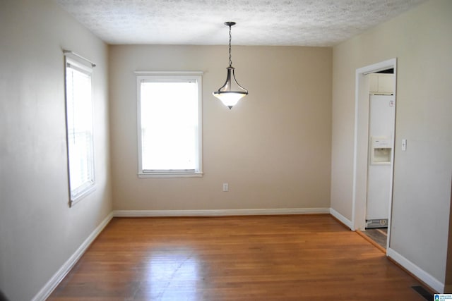 602 Riddle Ave, Piedmont, AL 36272 - unfurnished room featuring baseboards, a textured ceiling, visible vents, and wood finished floors