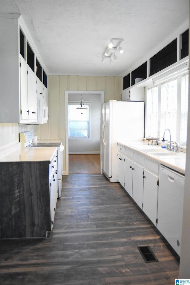 602 Riddle Ave, Piedmont, AL 36272 - kitchen featuring visible vents, dark wood finished floors, a sink, light countertops, and white appliances