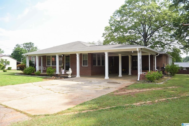 602 Riddle Ave, Piedmont, AL 36272 - view of front of house with covered porch, brick siding, a front lawn, concrete driveway, and an attached carport