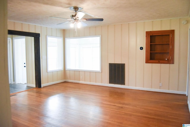 602 Riddle Ave, Piedmont, AL 36272 - unfurnished room with a ceiling fan, baseboards, visible vents, and wood finished floors