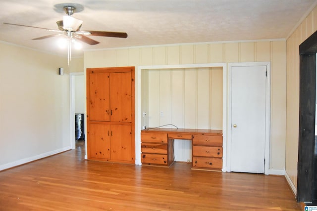 602 Riddle Ave, Piedmont, AL 36272 - unfurnished bedroom featuring baseboards, ornamental molding, built in desk, and wood finished floors