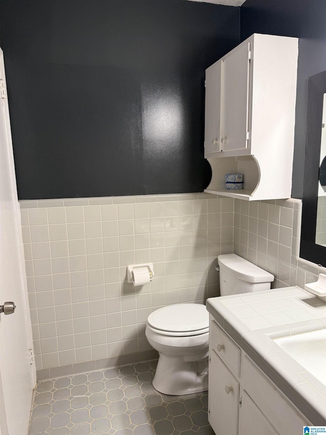 602 Riddle Ave, Piedmont, AL 36272 - bathroom with tile walls, vanity, and toilet