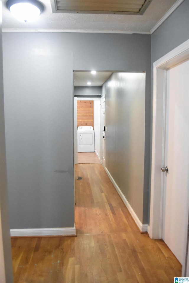 602 Riddle Ave, Piedmont, AL 36272 - hall featuring light wood-style floors, baseboards, ornamental molding, and washer / clothes dryer