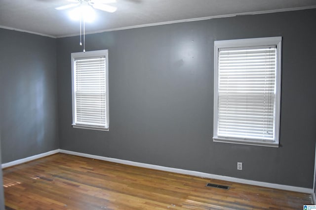 602 Riddle Ave, Piedmont, AL 36272 - spare room with crown molding, a ceiling fan, baseboards, wood finished floors, and visible vents