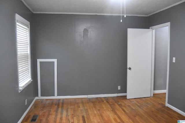 602 Riddle Ave, Piedmont, AL 36272 - spare room featuring crown molding, baseboards, plenty of natural light, and wood finished floors