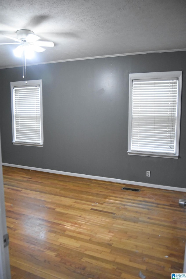 602 Riddle Ave, Piedmont, AL 36272 - spare room with a ceiling fan, visible vents, ornamental molding, and wood finished floors
