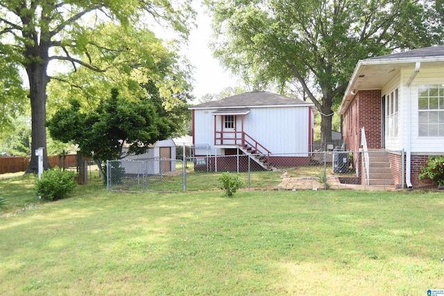 602 Riddle Ave, Piedmont, AL 36272 - rear view of house featuring a gate, an outdoor structure, a yard, and fence private yard
