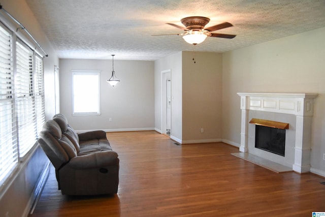 602 Riddle Ave, Piedmont, AL 36272 - living room featuring baseboards, a ceiling fan, a textured ceiling, and wood finished floors