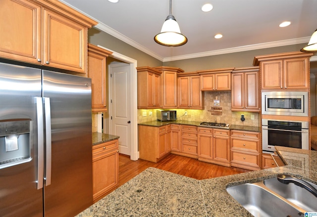 1103 Greystone Cove Dr, Hoover, AL 35242 - kitchen featuring ornamental molding, wood finished floors, a sink, appliances with stainless steel finishes, and decorative light fixtures