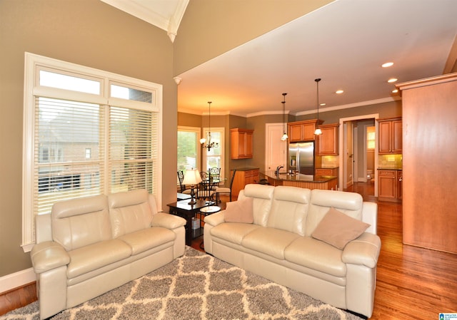1103 Greystone Cove Dr, Hoover, AL 35242 - living area with an inviting chandelier, ornamental molding, baseboards, recessed lighting, and light wood finished floors