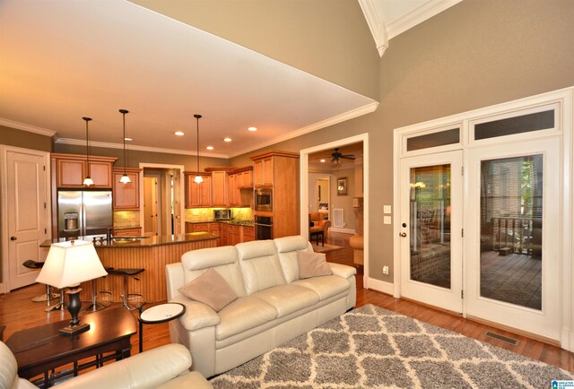 1103 Greystone Cove Dr, Hoover, AL 35242 - living room featuring crown molding, ceiling fan, wood finished floors, and visible vents