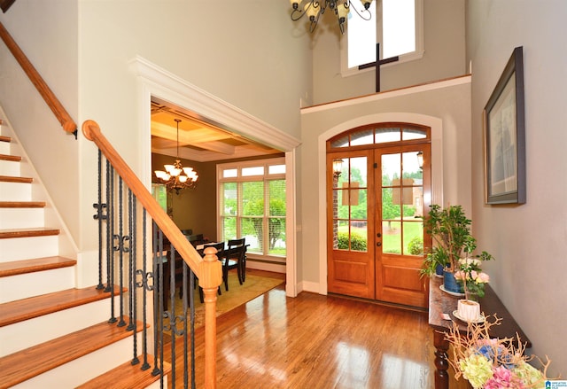 1103 Greystone Cove Dr, Hoover, AL 35242 - foyer featuring plenty of natural light, stairs, wood finished floors, and a notable chandelier