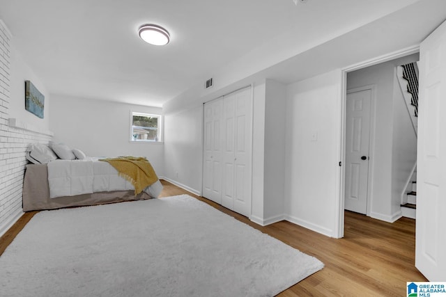 917 Forrest Dr S, Homewood, AL 35209 - bedroom with baseboards, a closet, wood finished floors, and visible vents
