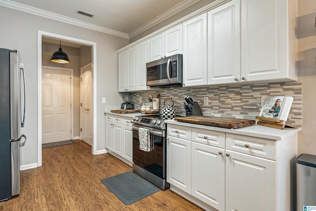 kitchen featuring stainless steel appliances, visible vents, white cabinetry, and wood finished floors