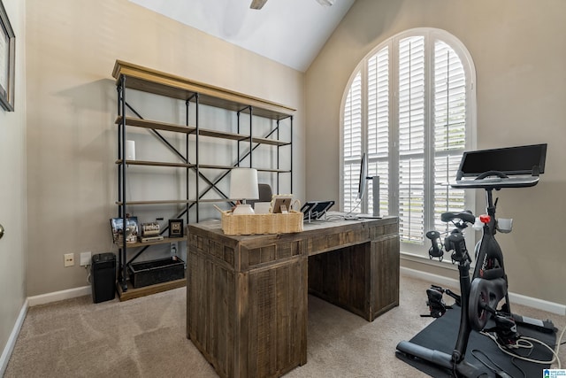 carpeted office space featuring a ceiling fan, baseboards, and lofted ceiling