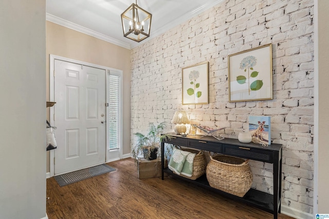 entryway with crown molding, baseboards, wood finished floors, and a chandelier