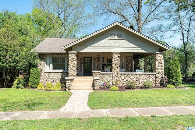 530 10th Ave S, Birmingham, AL 35205 - view of front of home featuring a porch, stone siding, and a front lawn