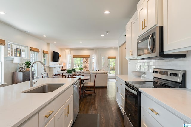 530 10th Ave S, Birmingham, AL 35205 - kitchen featuring dark wood-style flooring, appliances with stainless steel finishes, a sink, light countertops, and open floor plan