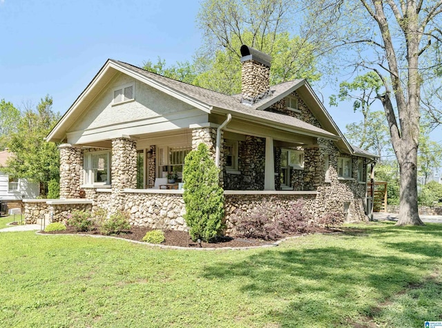 530 10th Ave S, Birmingham, AL 35205 - view of front of property featuring a chimney, a front lawn, stone siding, and a porch