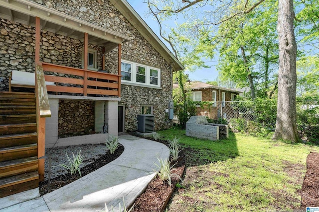 530 10th Ave S, Birmingham, AL 35205 - back of house featuring fence, cooling unit, and stone siding