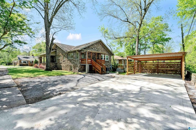 530 10th Ave S, Birmingham, AL 35205 - view of front of home featuring a carport, a front yard, driveway, and stone siding