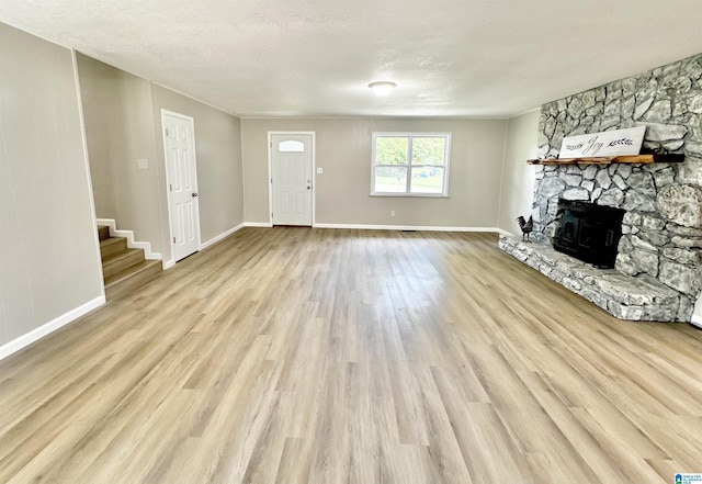 5482 Hackberry Ln N, Gadsden, AL 35903 - unfurnished living room featuring stairs, baseboards, wood finished floors, and a fireplace