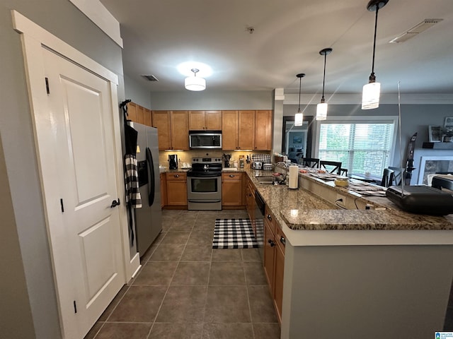 475 River Forest Ln Unit 1250, Talladega, AL 35160 - kitchen with a peninsula, appliances with stainless steel finishes, brown cabinetry, and visible vents