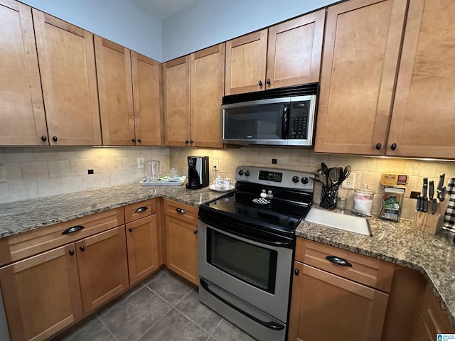 475 River Forest Ln Unit 1250, Talladega, AL 35160 - kitchen with stainless steel electric range oven, dark tile patterned floors, stone countertops, and tasteful backsplash