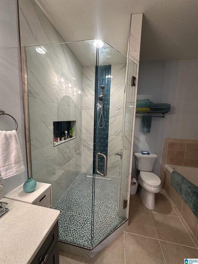 475 River Forest Ln Unit 1250, Talladega, AL 35160 - bathroom with tile patterned flooring, vanity, toilet, a tub, and a shower stall